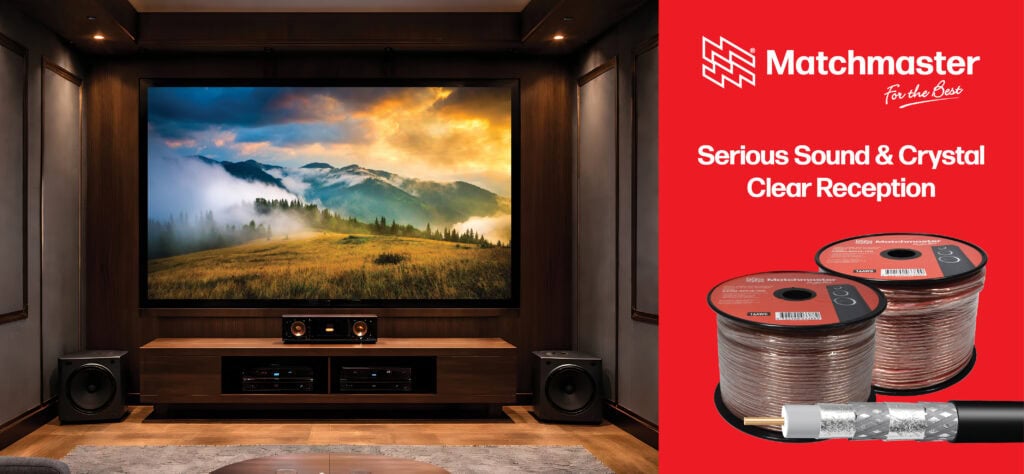 Home theatre setup with large screen and surround sound speakers in a cozy room.