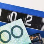 High-quality Australian currency notes and a coin counter machine for cash handling.